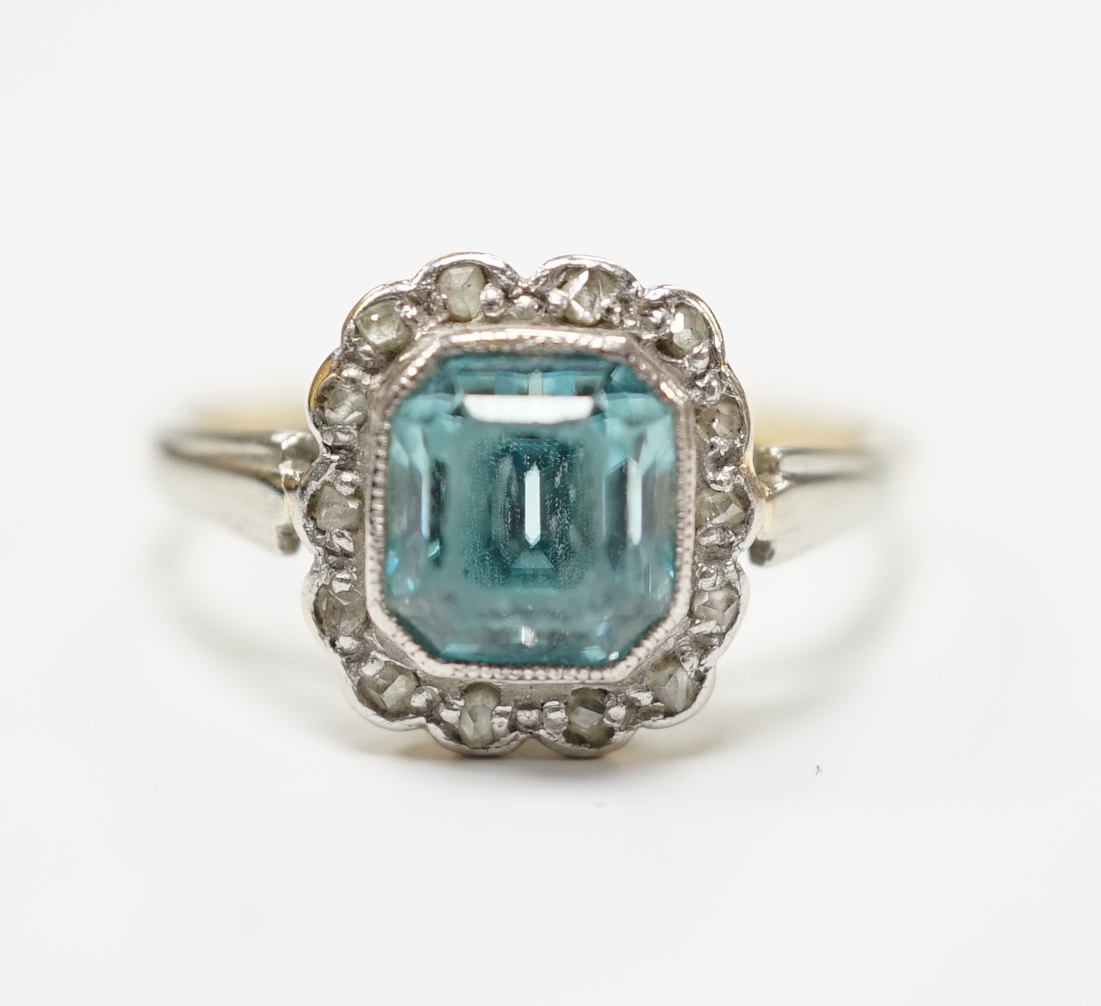 An 18ct and plat, blue zircon and diamond chip cluster set ring, size O, gross weight 3.4 grams.
